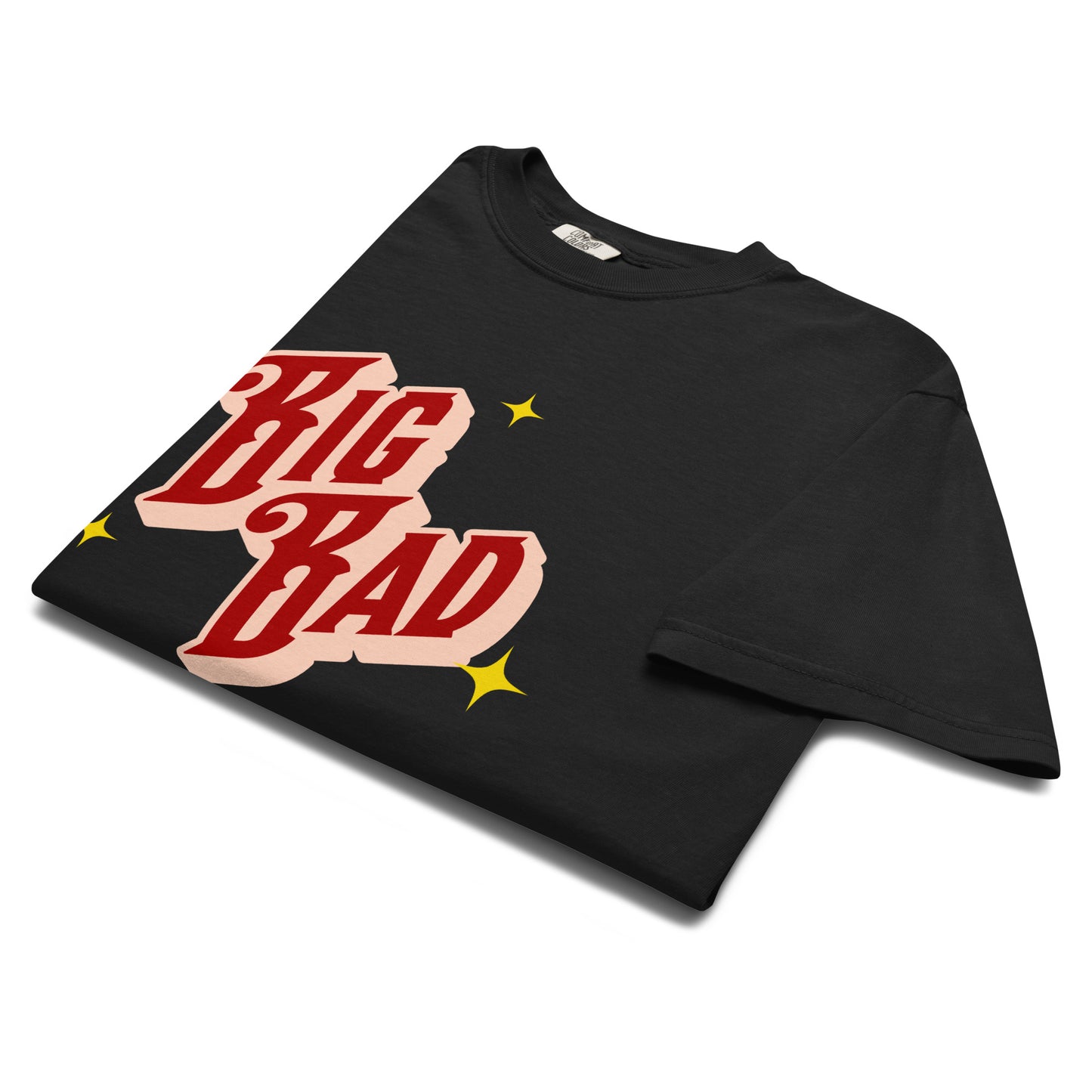 Folded black t-shirt showing vintage red and cream ‘Big Bad’ text design with small yellow stars.
