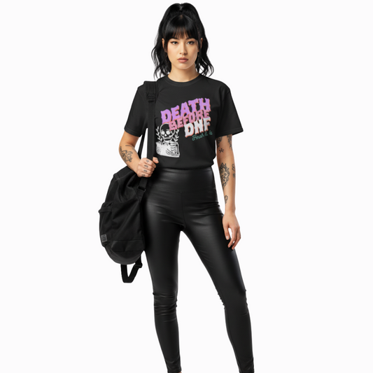 Model wearing black “Death Before DNF” t-shirt with bold distressed lettering and skeleton artwork, styled for an alternative, punk, or witchy aesthetic.