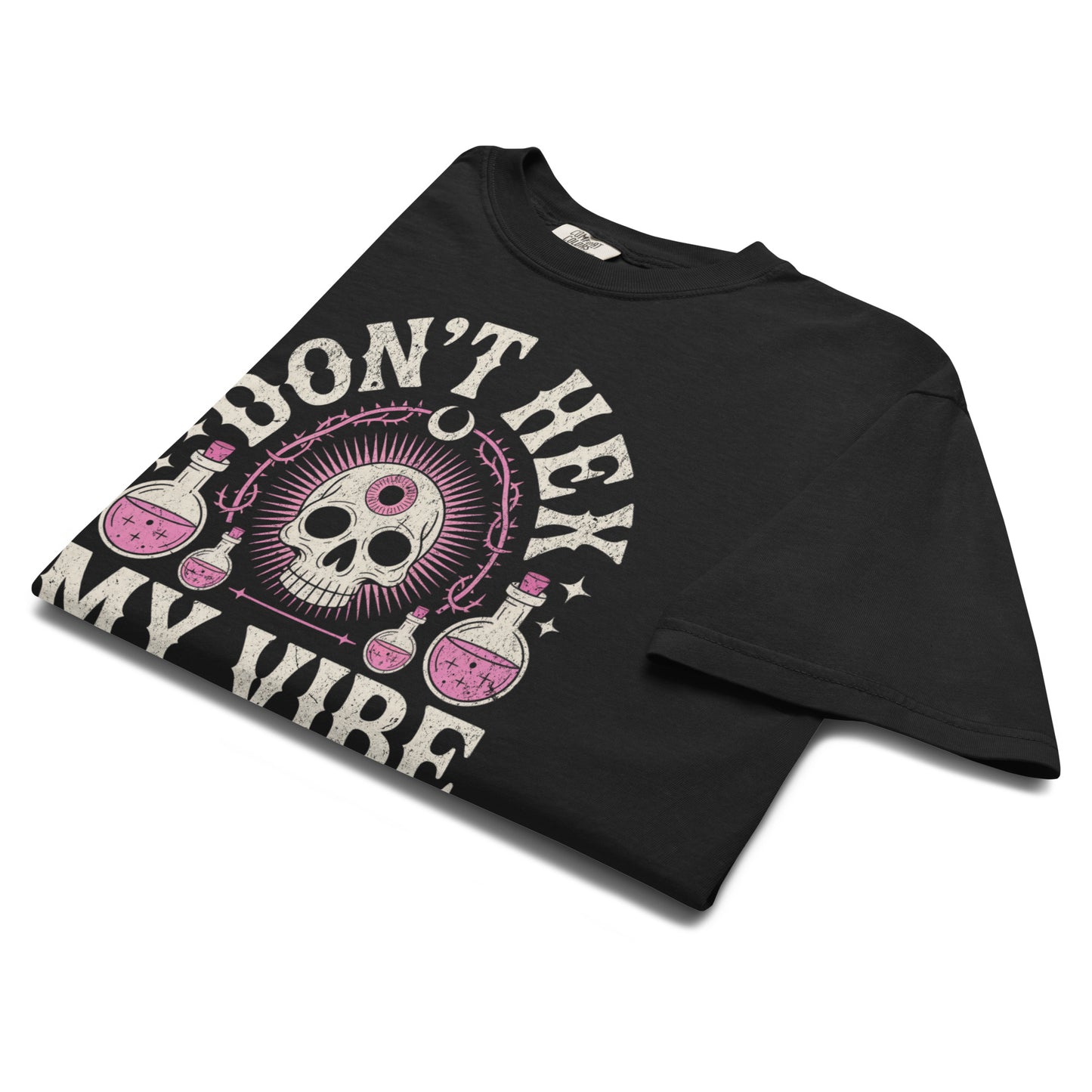 Folded Don’t Hex My Vibe T-shirt highlighting vintage pink skull and potion artwork