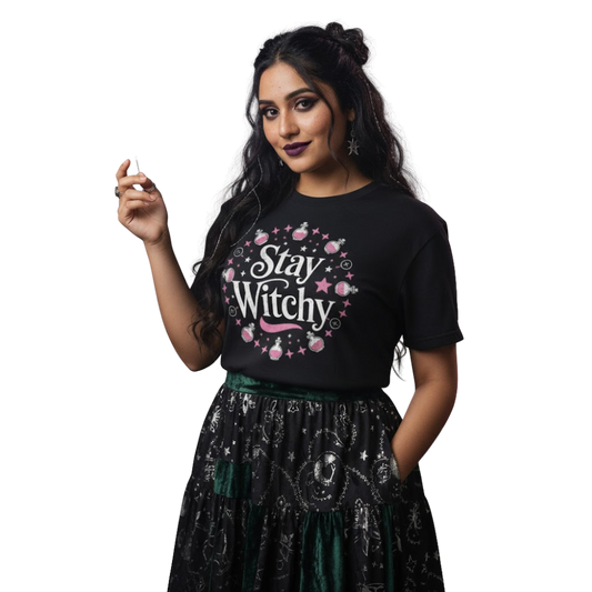 Model wearing black “Stay Witchy” t-shirt with pink and white celestial artwork, styled with a black skirt for a soft gothic or witchy fashion look.