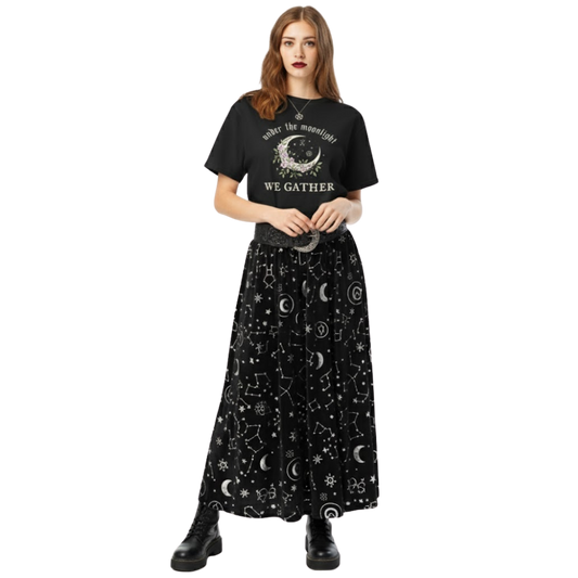 Model wearing black “Under the Moonlight We Gather” graphic tee paired with a celestial skirt, showcasing a witchy moon aesthetic outfit.