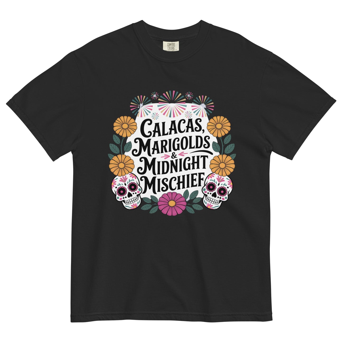 Black t-shirt with colorful Día de los Muertos design featuring sugar skulls, marigolds, and the phrase ‘Calacas, Marigolds & Midnight Mischief’ displayed flat on white background.