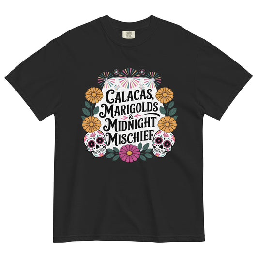Black t-shirt with colorful Día de los Muertos design featuring sugar skulls, marigolds, and the phrase ‘Calacas, Marigolds & Midnight Mischief’ displayed flat on white background.