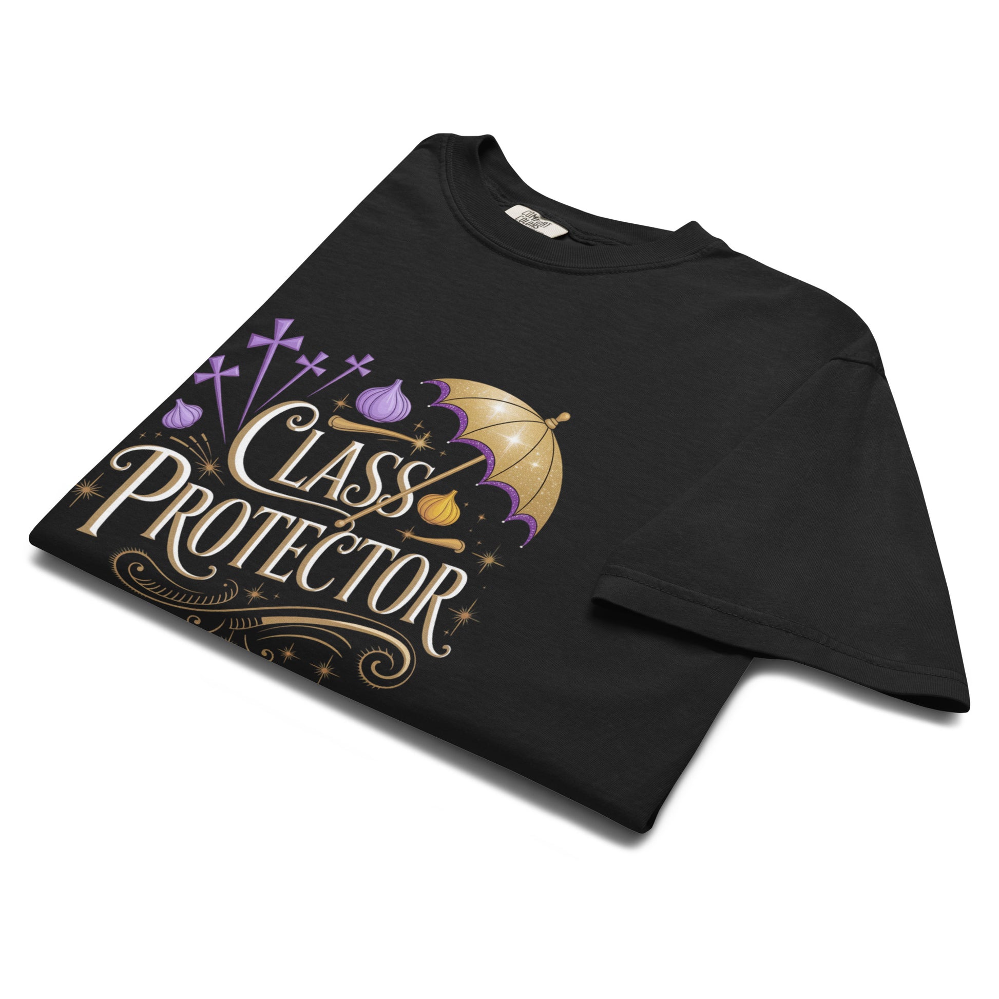 Folded black t-shirt showing detailed design with text ‘Class Protector,’ purple crosses, and a gold umbrella accent.