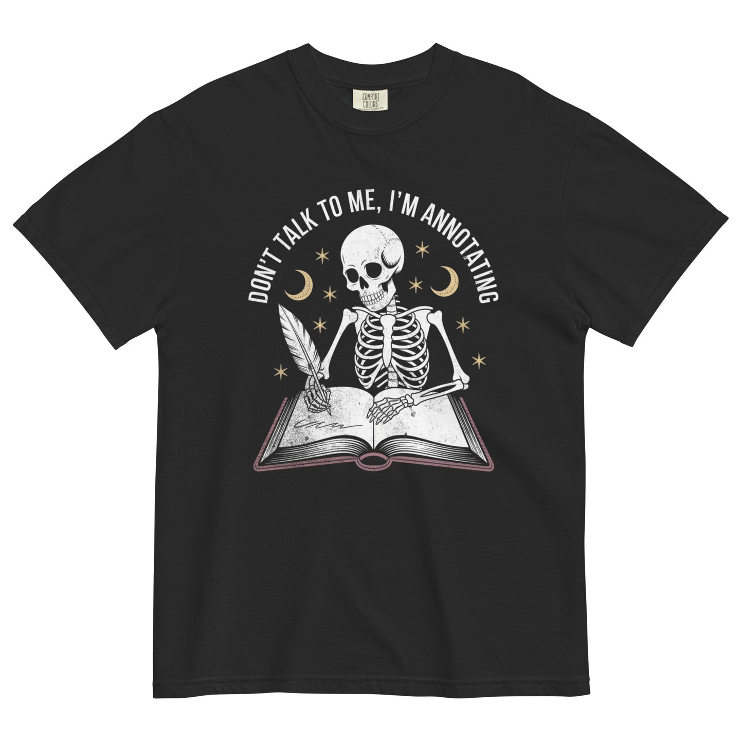 Skeleton writing in a book under moon and stars with quote ‘Don’t talk to me, I’m annotating’ on a black t-shirt.