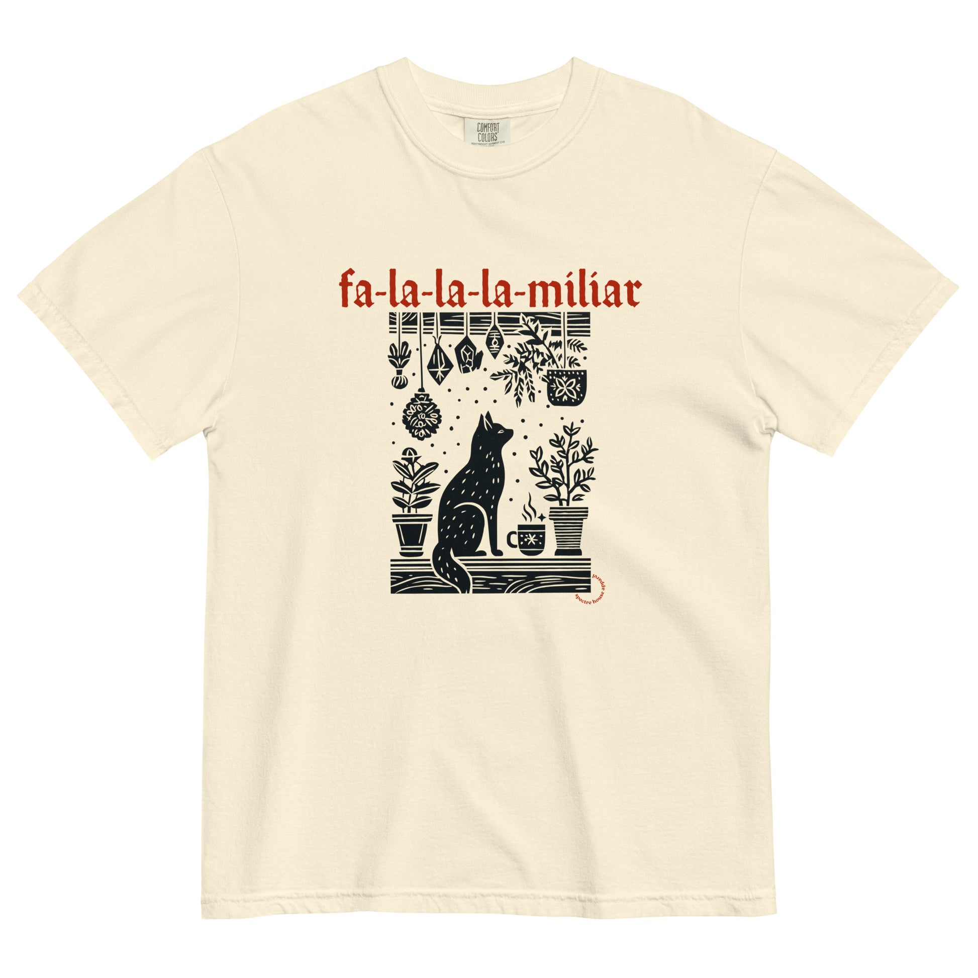 Fa-La-La-La-Miliar Familiar Cat Holiday Tee shown flat on a neutral background, featuring a black cat, herbs, and red gothic lettering.