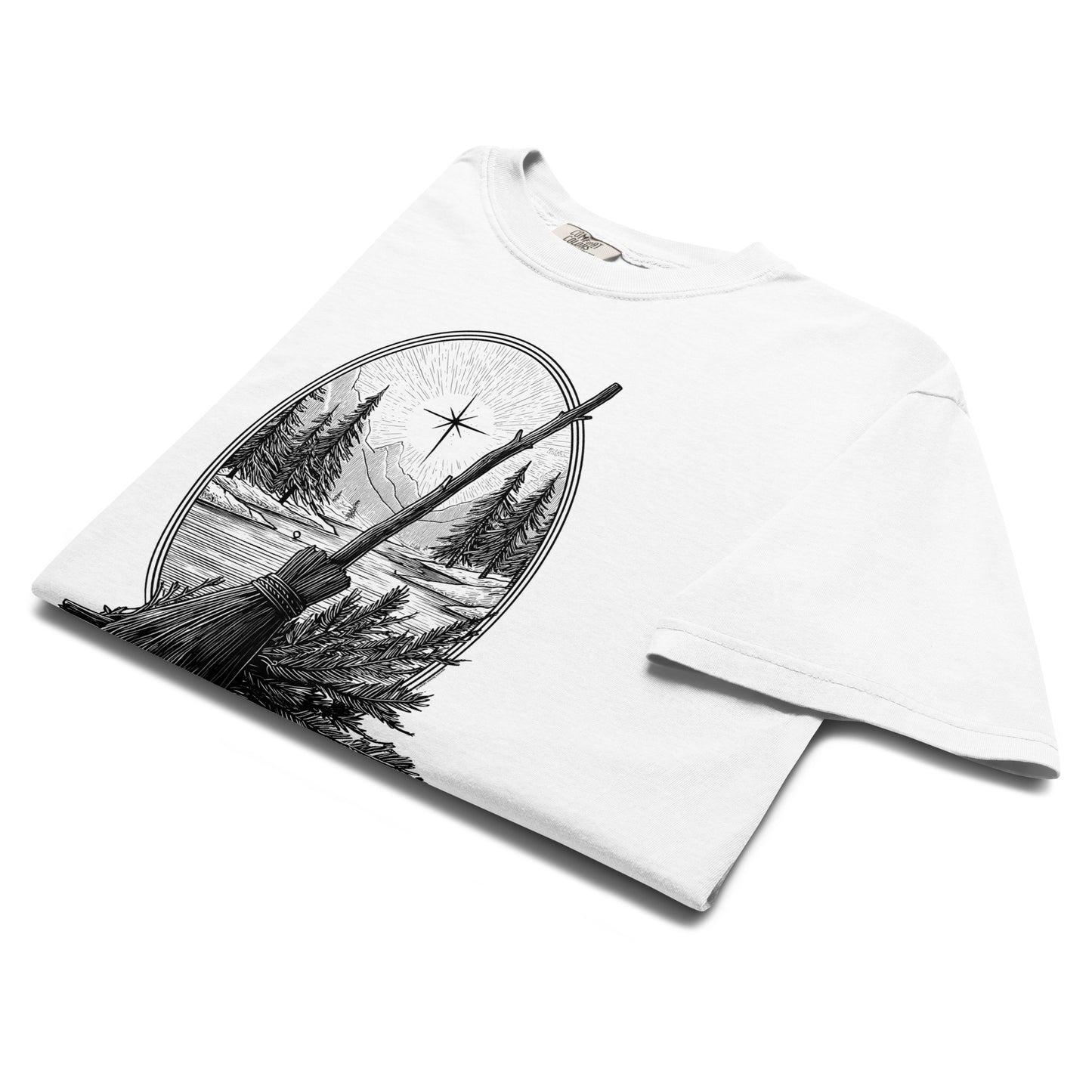 Folded lay-flat view of white “Happy Solstice” T-shirt showing detailed broomstick and solstice sun illustration.