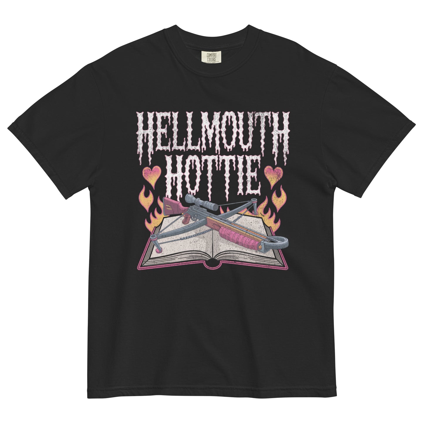 Black t-shirt lay flat featuring pink gothic “Hellmouth Hottie” text above an open spellbook with flames, hearts, and daggers — a darkly flirty witchy graphic tee.