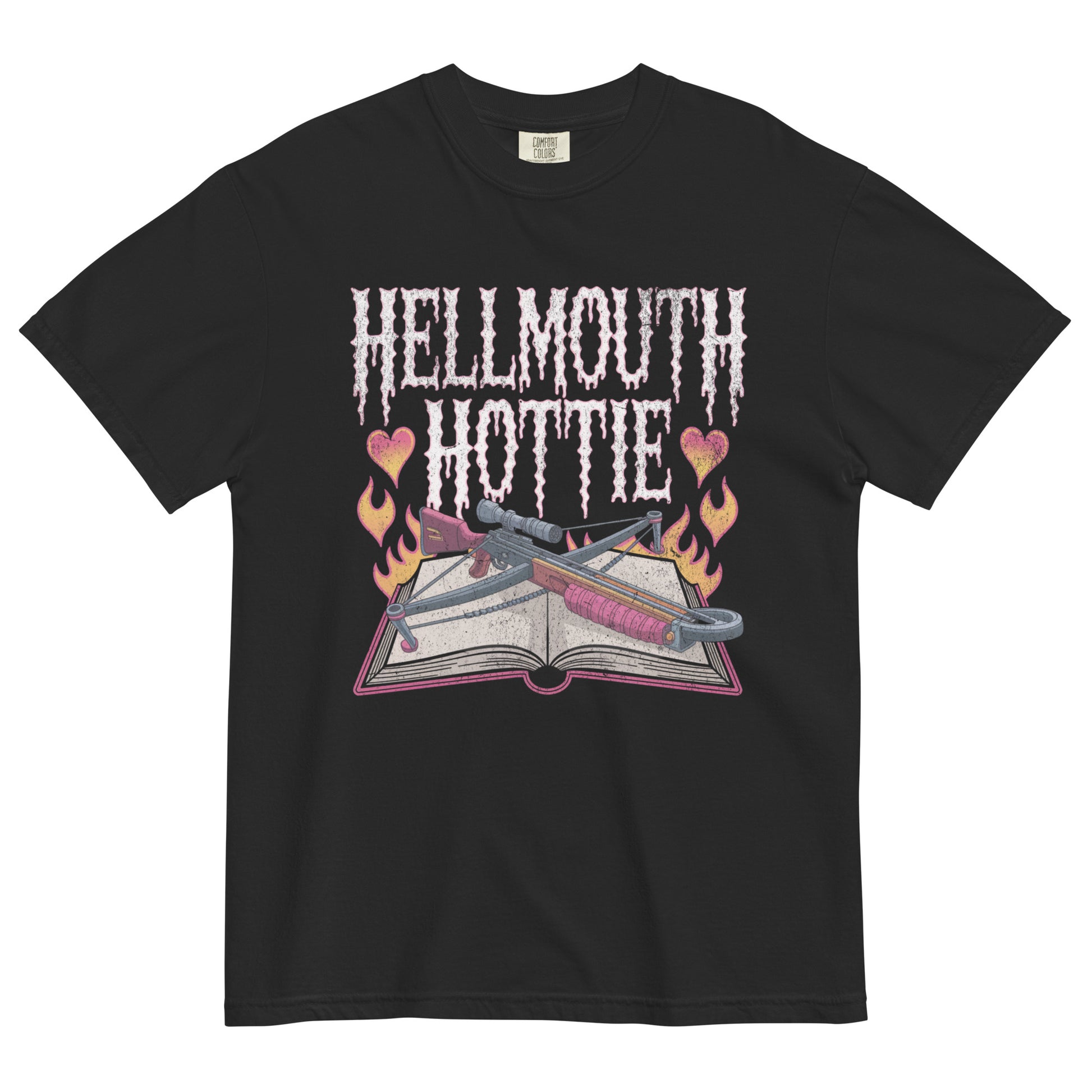 Black t-shirt lay flat featuring pink gothic “Hellmouth Hottie” text above an open spellbook with flames, hearts, and daggers — a darkly flirty witchy graphic tee.