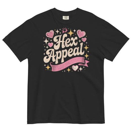 Black t-shirt lay flat featuring sparkly pink and gold “Hex Appeal” text with hearts and stars, a cute witchy graphic tee with retro charm and magical energy.