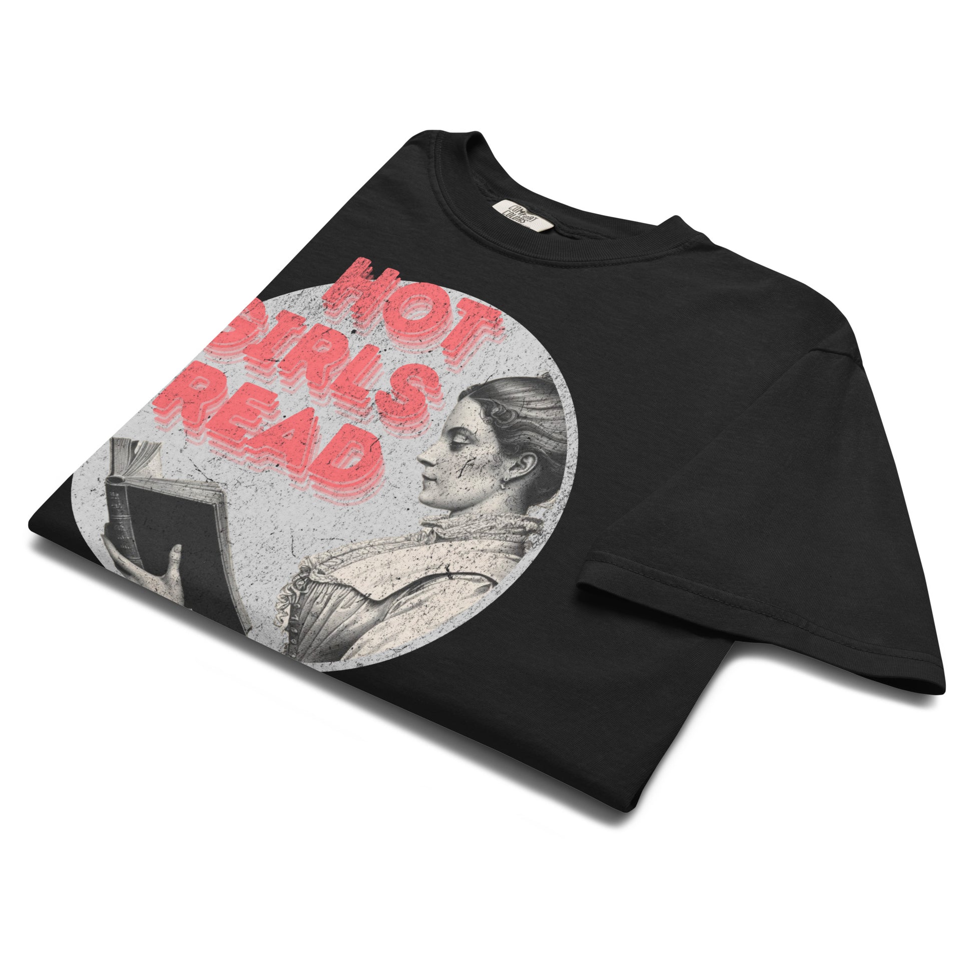 Folded black “Hot Girls Read” t-shirt flat lay showing retro reader artwork and distressed lettering, perfect for bibliophiles with attitude.