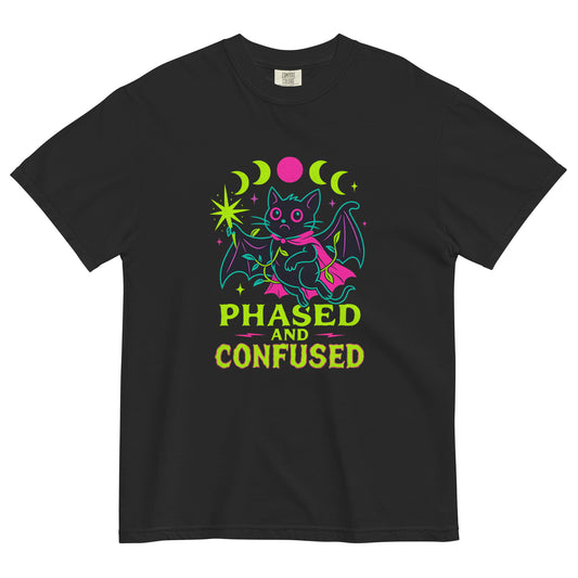 Phased and Confused bat graphic t-shirt laid flat on a black background, featuring a neon pink and green moon phase design with a cute gothic bat illustration.