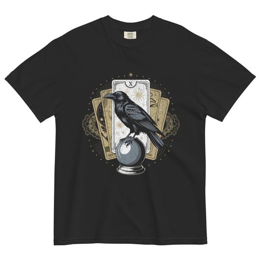 Black t-shirt lay flat featuring a raven perched on a crystal ball with tarot cards and gold celestial detailing, a mystical occult-inspired graphic tee.