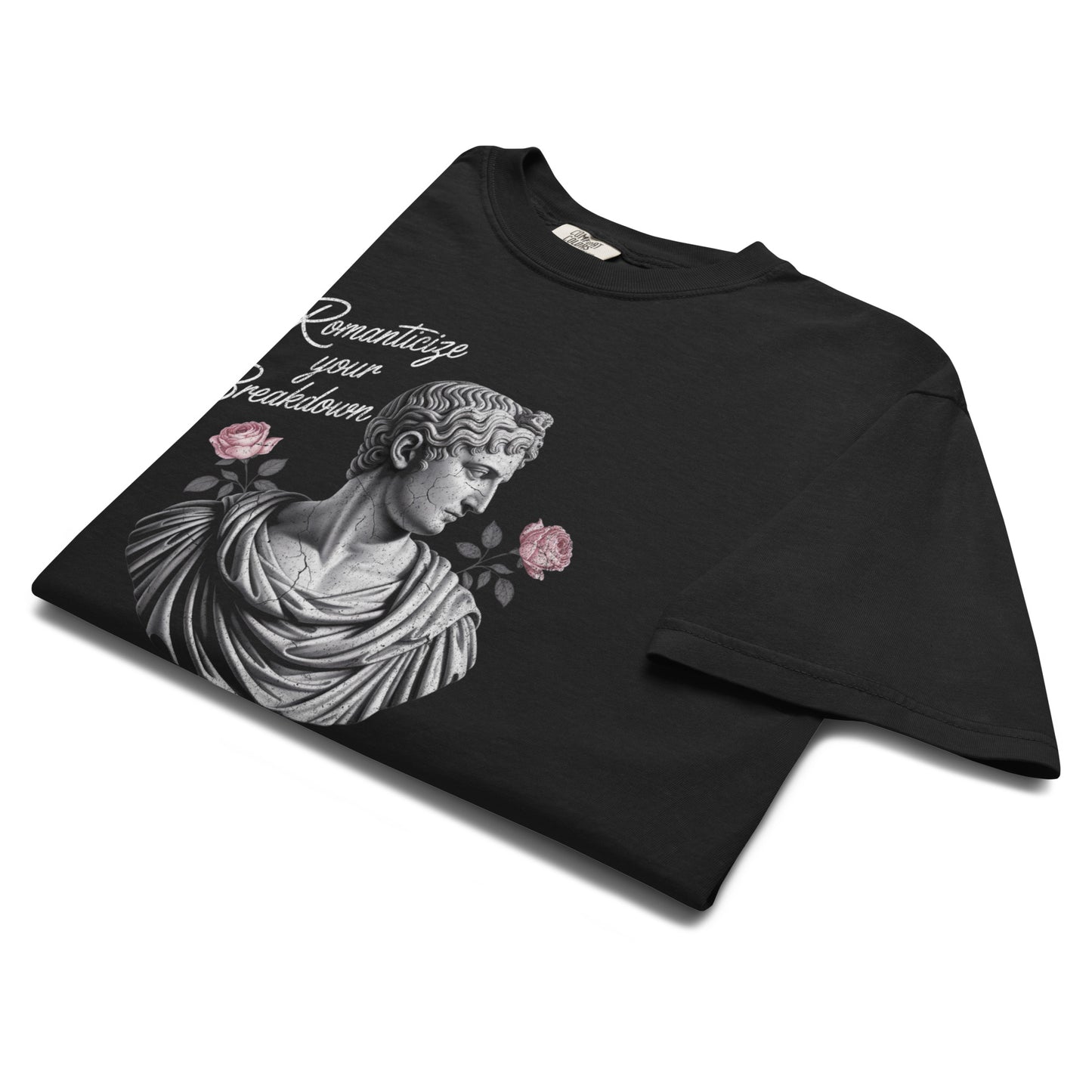 Folded black “Romanticize Your Breakdown” t-shirt flat lay showing detailed statue artwork and floral accents, perfect for fans of melancholy art and alt fashion.
