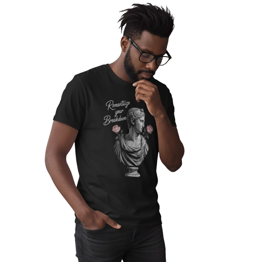 Model wearing black “Romanticize Your Breakdown” t-shirt with marble statue and pink rose design, styled for an artistic, moody aesthetic.