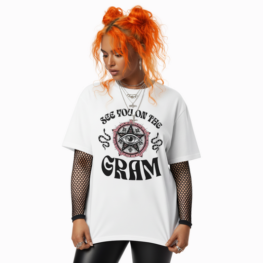 Model wearing white “See You on the Gram” t-shirt featuring mystical eye artwork and bold retro typography, styled with black mesh sleeves for an edgy alt look.