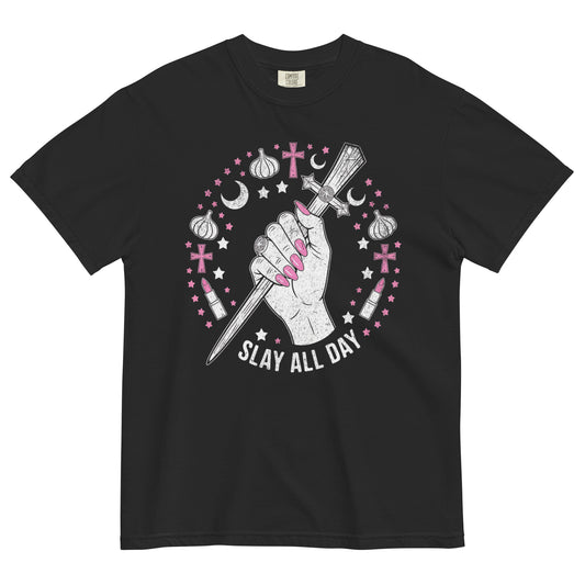 Black t-shirt lay flat featuring a hand gripping a wooden stake surrounded by pink stars, moons, and garlic bulbs with text “Slay All Day,” a Buffy the Vampire Slayer–inspired gothic tee.