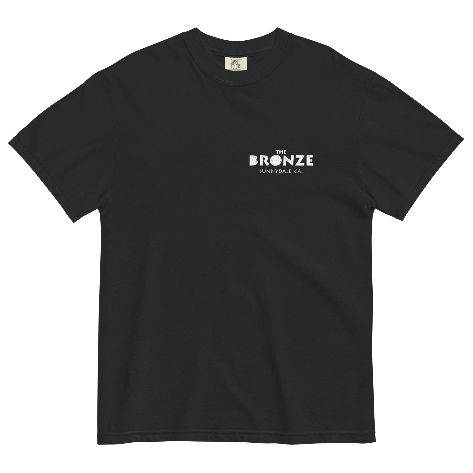 Black t-shirt laid flat with small white text logo reading ‘The Bronze, Sunnydale CA’ on the front left chest.