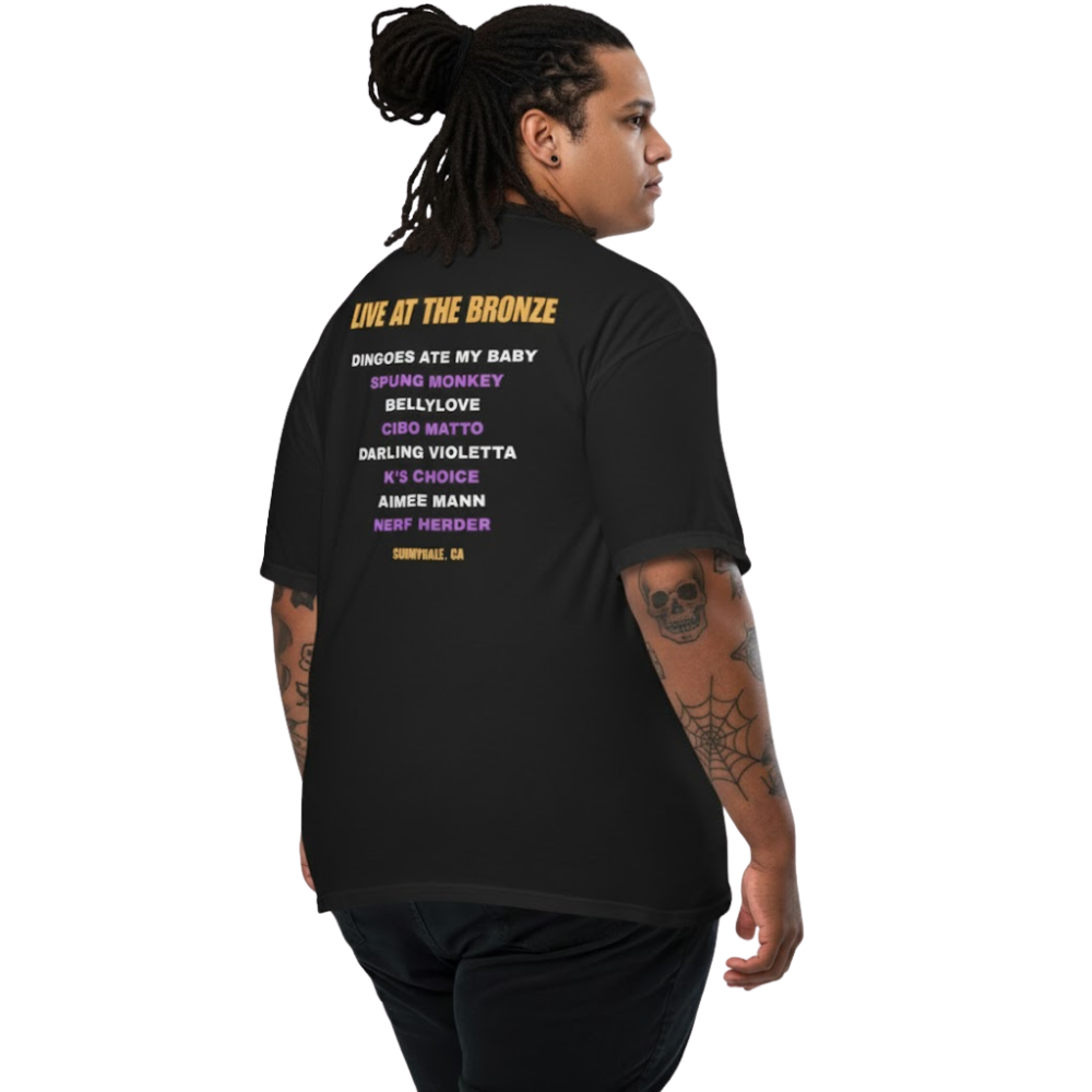 Model wearing a black t-shirt with ‘Live at The Bronze’ printed on the back in purple and yellow text; vintage concert-style design.