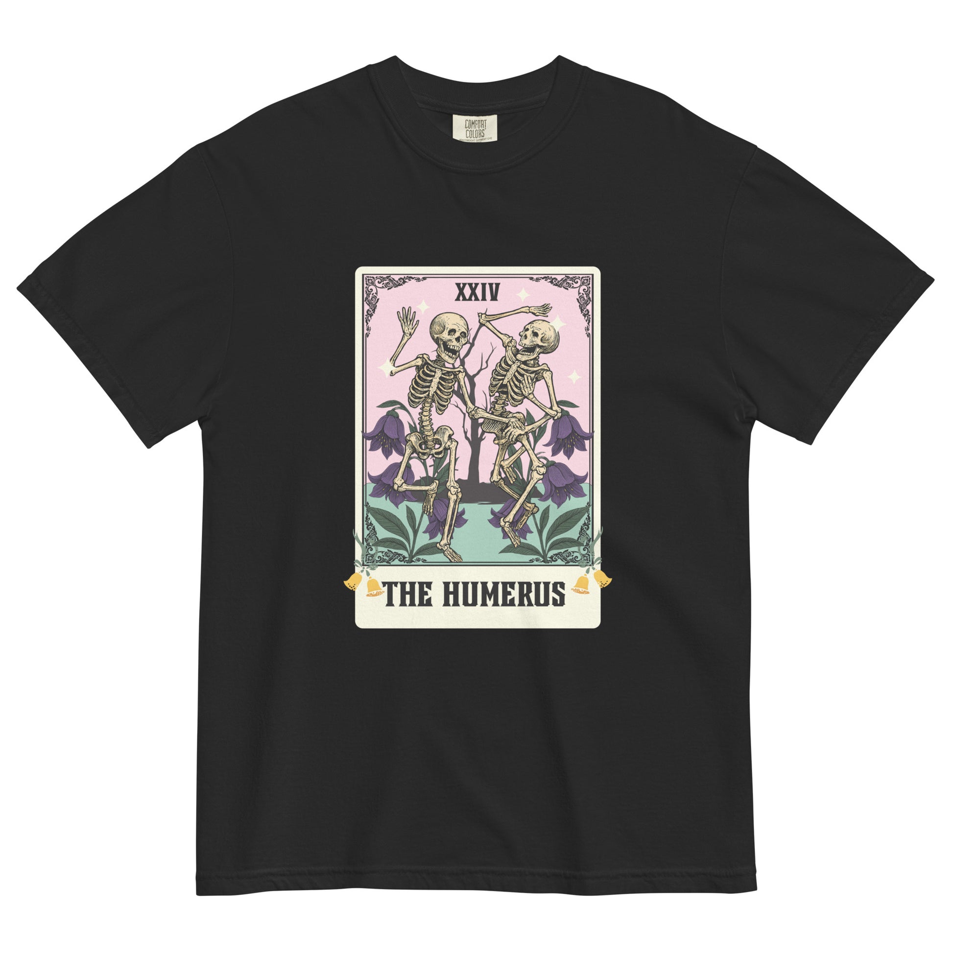 Black t-shirt lay flat featuring “The Humerus” tarot card-style design with two skeletons and floral details, a witty occult-inspired graphic tee with pastel tones.