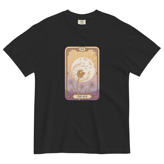 Black t-shirt lay flat featuring “The Sun” tarot card design with a radiant floral motif in warm gold and lavender tones, a mystical and vintage-inspired tee.