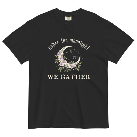 Black t-shirt with a crescent moon and floral design reading “Under the Moonlight We Gather,” a mystical witchy graphic tee for moon lovers and spiritual gatherings.