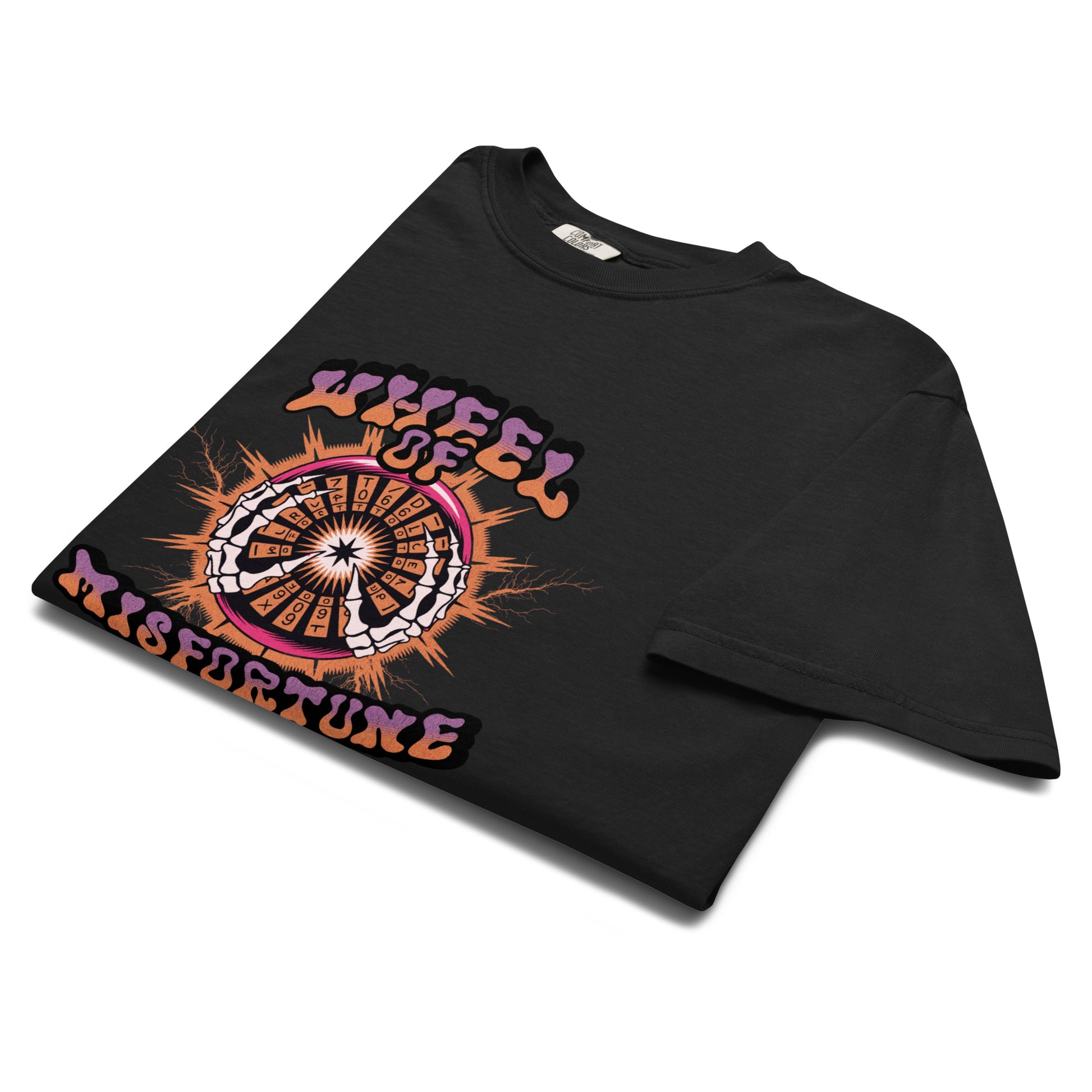 Folded black “Wheel of Misfortune” t-shirt flat lay showing tarot-style illustration and flame accents, perfect for dark humor and occult aesthetic fans.