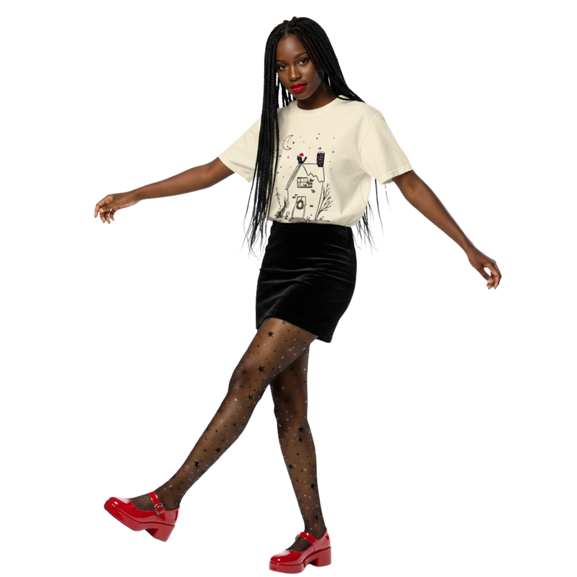 Woman wearing ivory witchy cottage holiday T-shirt with moon and wreath design, styled with black skirt and red heels.