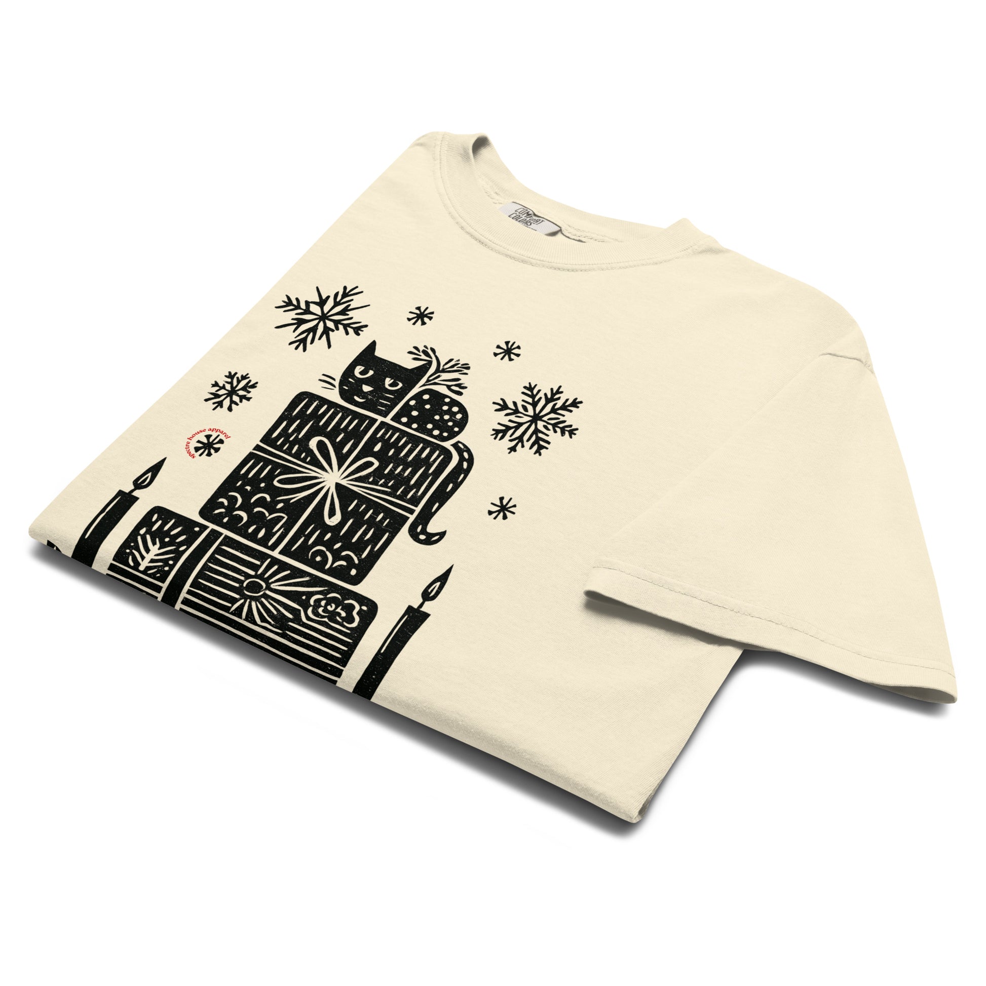 Front and back lay-flat display of ivory witchy holiday T-shirt with candle and snowflake details, printed on premium Comfort Colors cotton.